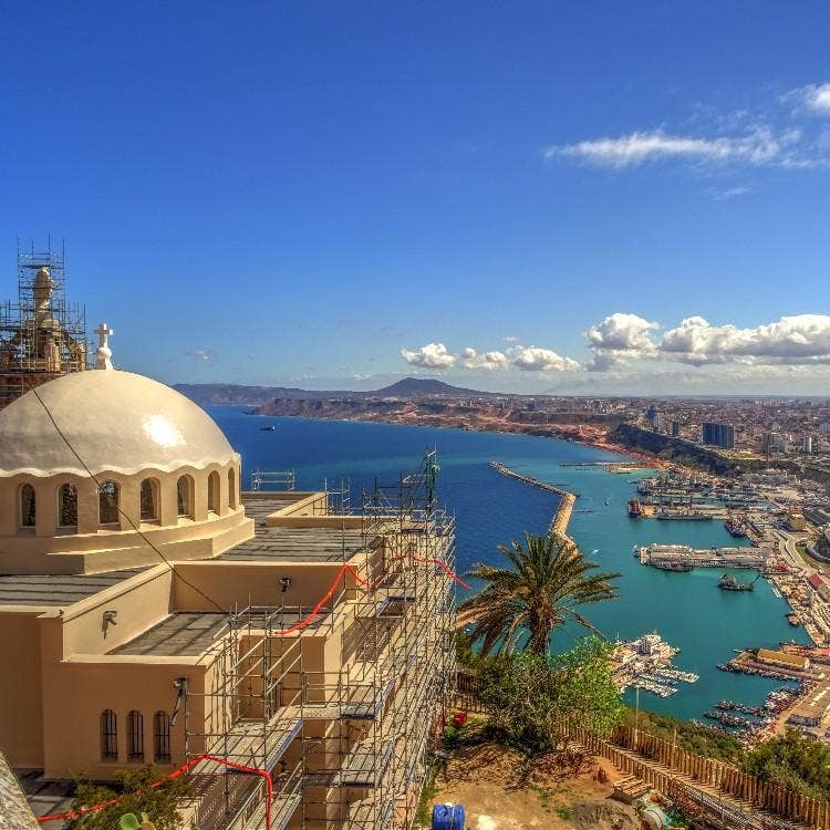 The Chapelle de Santa Cruz under scaffolding, overlooking the city harbor and Mediterranean Sea in Oran, Algeria.